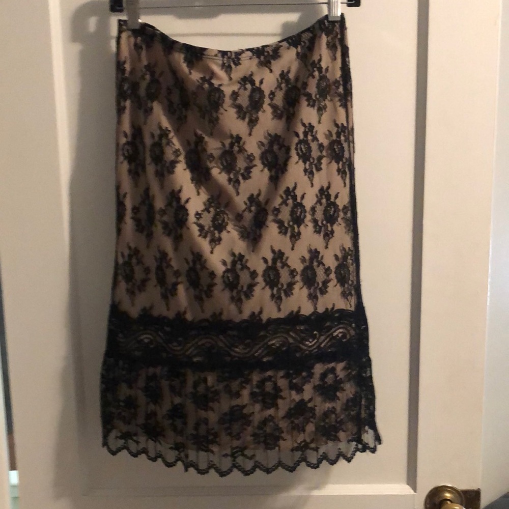 Vintage black lace skirt lined with tan slip just past the knees